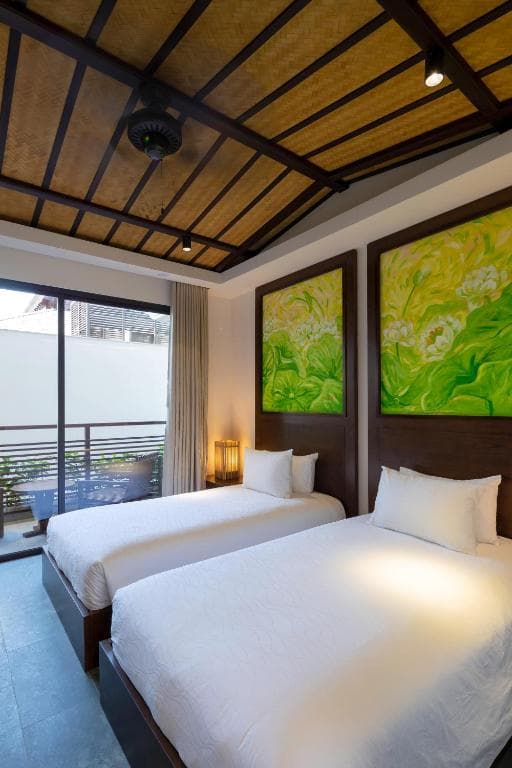 The two single beds of the Ying and Yang twin room beneath a vaulted timber ceiling