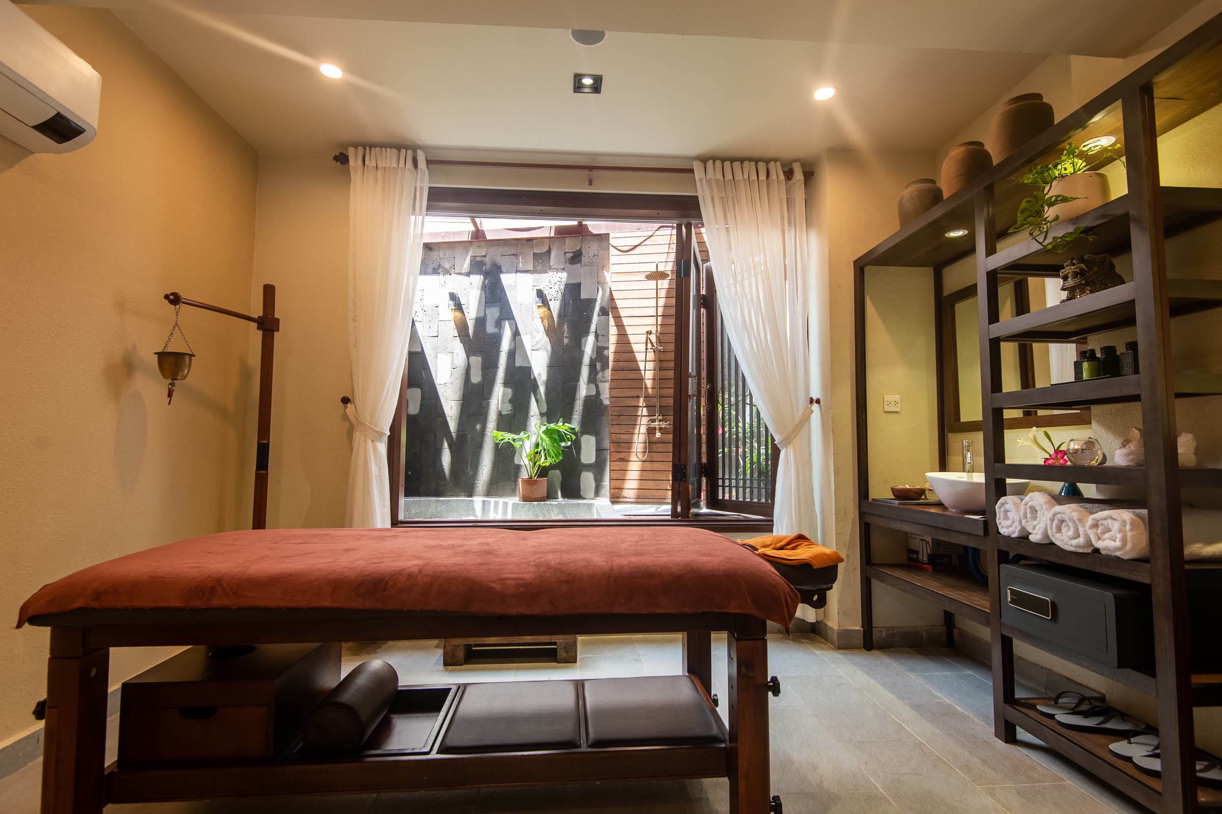 A single treatment room at Nghê Prana spa, set with fresh towels and warm light