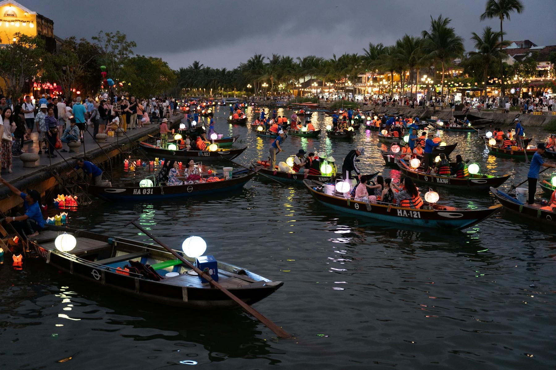 Silk lanterns glowing along the Thu Bồn river at Hội An on a full-moon night — among the most romantic things to do in Hội An for couples, from Nghê Prana at Cẩm Nam.